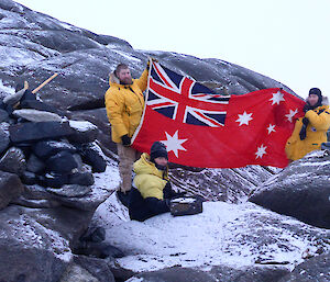 Glen, Simon and Derryn holding up an Australian Red Ensign flag at Sir Hubert Wilkins Cairn.