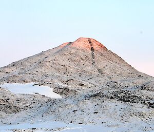 The winter sun lighting up a dyke on the side of a hill at Lake Druzhby.