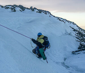 Graham being pulled up the ice slope by the rescue line.