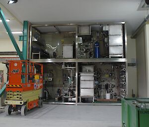 The two large section of the waste water treatment plant, one on top of the other and in position with the elevated work platform parked on the left.