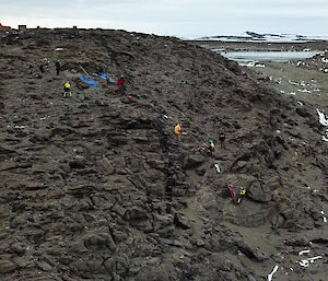 Aerial photo of the search and rescue team doing some technical rope training one a rocky ledge.