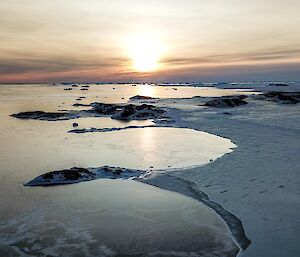 Aerial photo of the sea ice edge with new ice forming on the left side of the breakout line.