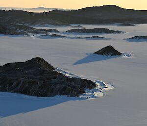 The Rauer Islands and sea ice, as viewed looking down from a high rocky outcrop