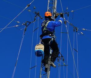 Expeditioner assessing the antenna repair at the top of the mast