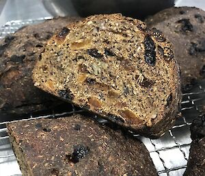 Fruit loaf cut in half on the airing rack.