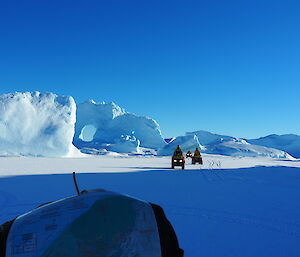 Three quad bikes exploring the icebergs on the sea ice