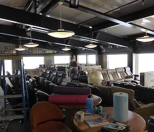 Chairs, tables stacked in the lounge area to clean the cinema, library and quiet room