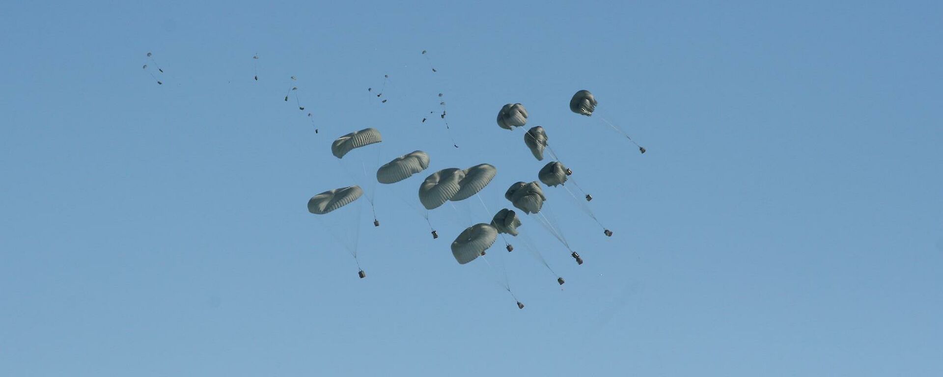 Cargo being delivered by parachute out the back of a C-17 RAAF aircraft.
