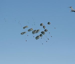 Cargo being delivered by parachute out the back of a C-17 RAAF aircraft.