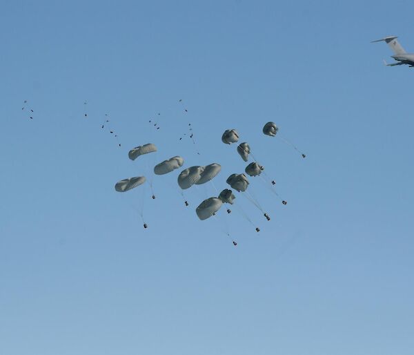 Cargo being delivered by parachute out the back of a C-17 RAAF aircraft.