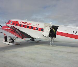 Captain and pilot of the Basler steps down from the Chinare plane onto the sea ice.