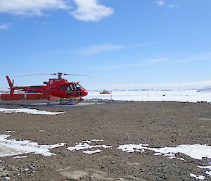 Helicopter with icebreaker in background
