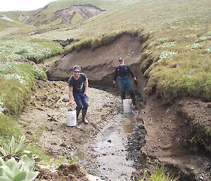 Scotty and Keon collect rocks for gabion construction