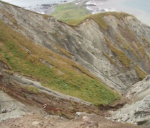 Two male expeditioners can be seen repairing the water line