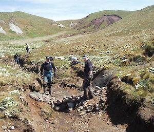 Ranger in charge Chris (right) with Scotty assisting, constructs a rock gabion