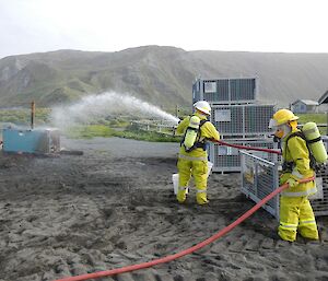 Paul and Benny attack the fire with simulated foam