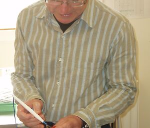 Doctor uses a surgical tool on a sausage during training