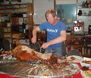 Mike carves the barbequed lamb