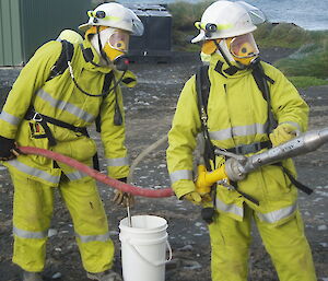 First responders Greg and Benny apply simulated foam