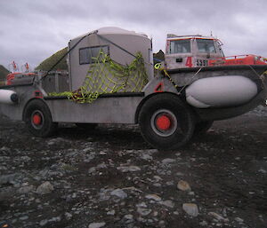 Water tanks hut loaded onto the amphibious vehicle.