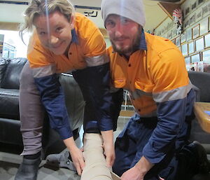 Two expeditioners holding a bandaged leg
