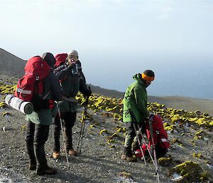 Three hikers stopping for a rest