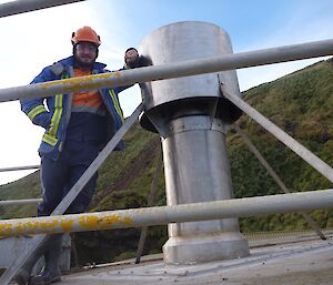 man standing on roof beside chimney