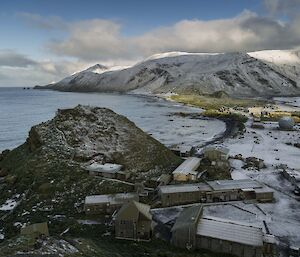 Morning sun over a snowy station and island