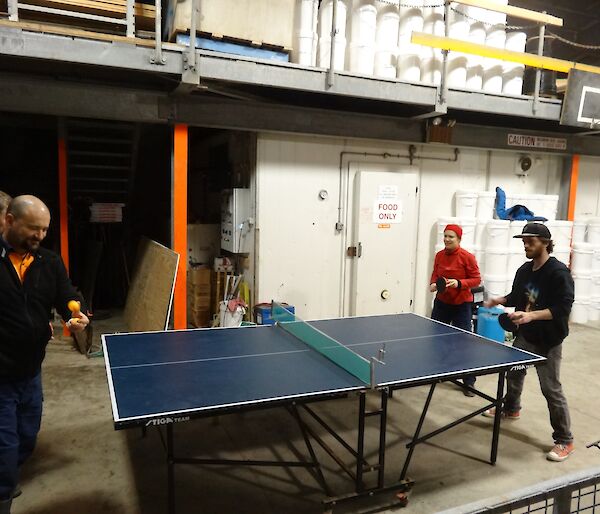 Four people playing table tennis