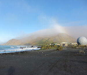 The plateau shrouded in cloud with a rainbow extending from it after the morning mist cleared from station