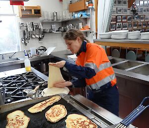 Anna at stove frying naan bread