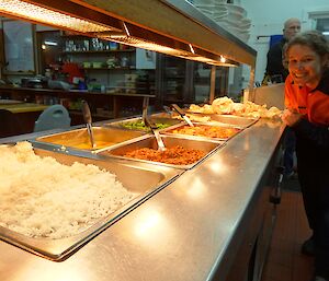 Anna in front of the curries in the bain marie