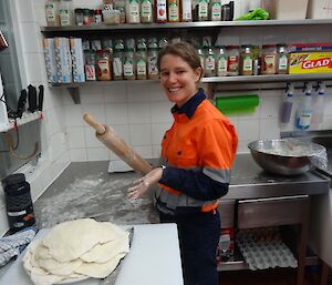 Anna rolling naan breads with a rolling pin