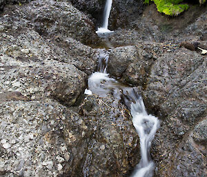 Small water fall down a series of large rocks