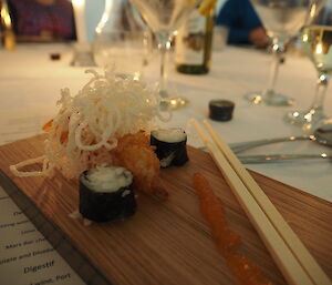 Szechuan braised duck dumplings with tomato chilli jam, prawn sushi and salmon roe