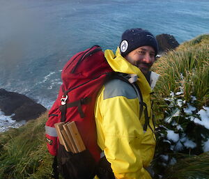 Expeditioner Duncan Bullock hiking on Macquarie Island.