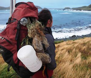 Andrea with backpack with bottles and ropes tied to outside