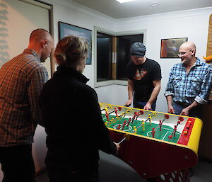 Four expeditioners playing foosball.