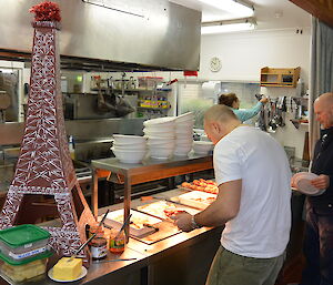 The mess kitchen with smoko in bain marie and Eiffel Tower statue in foreground