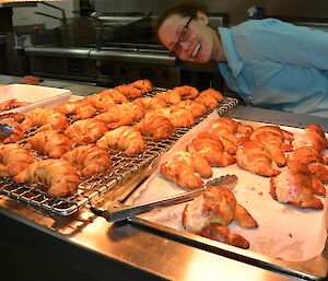 Louise looking through bain marie over freshly baked croissants