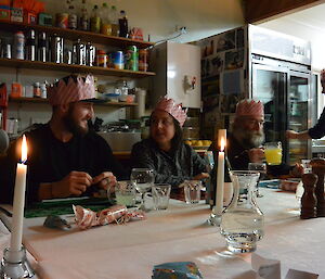 Expediotioners at table in party hats and christmas decorations