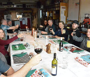 Expeditioners sitting around a table with christmas decorations