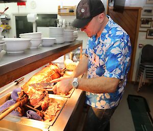 Justin carving up the luau pig