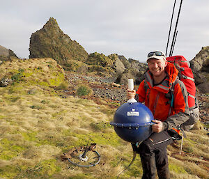 Rich standing holding a marine buoy