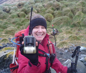 Anna holding the marine mammal tracking device