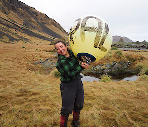 Andrea holding up a big yellow buoy