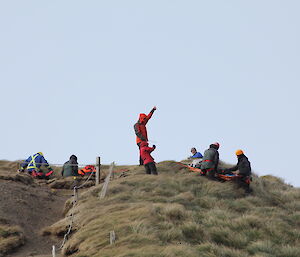 View up onto the hill where the team is standing ready to lower the stretcher