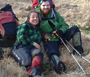 Andrea and Dan sitting in the grass smiling