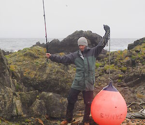 Ben triumphantly holding up a marine debris buoy