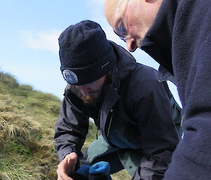 Ben and Nick administering first aid to a leg